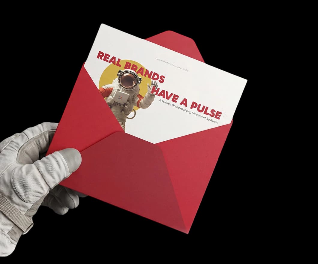 Real brands have a pulse - Astronaut holding red envelope